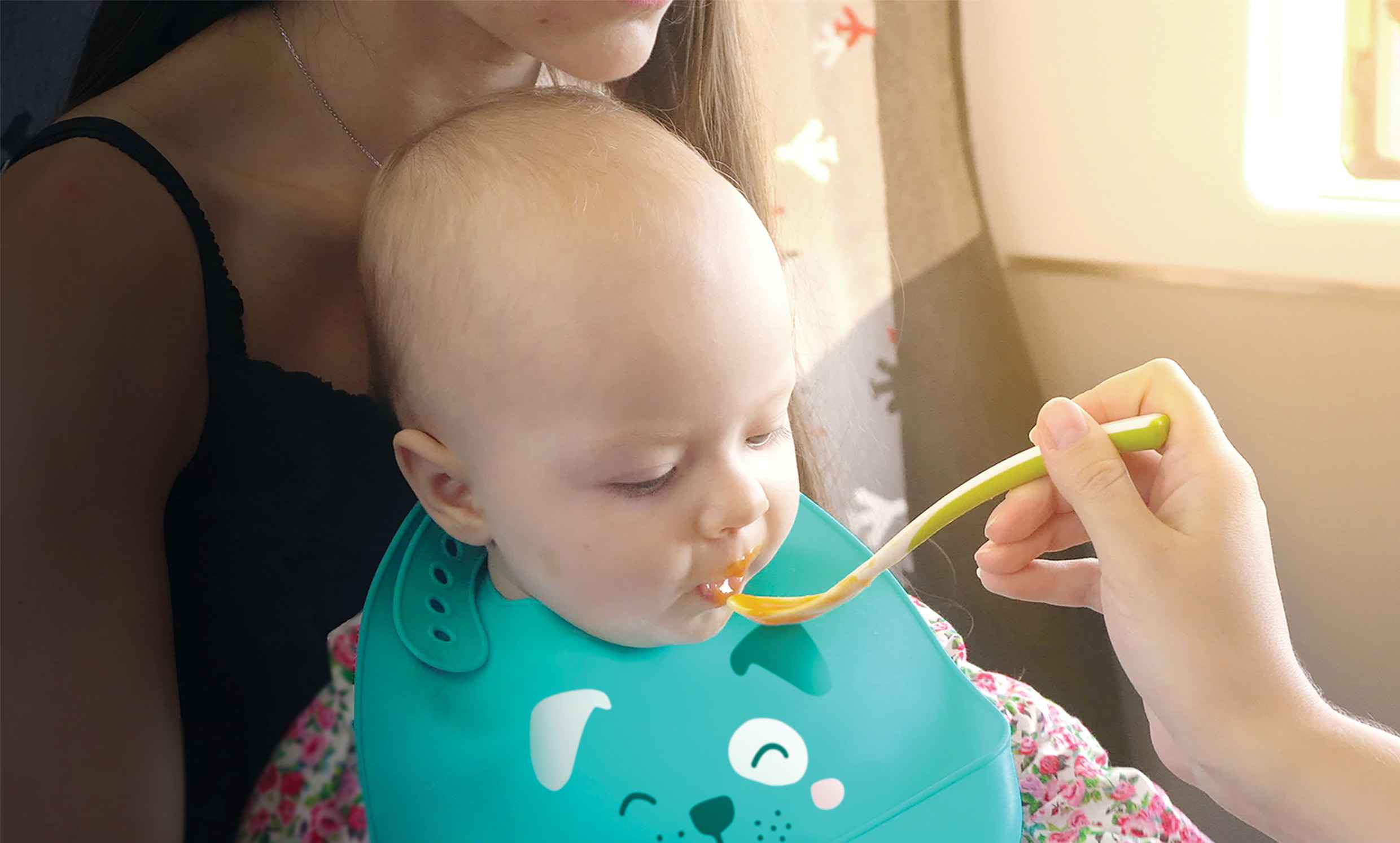 малюк їсть суп в слюнявчику Мантелло